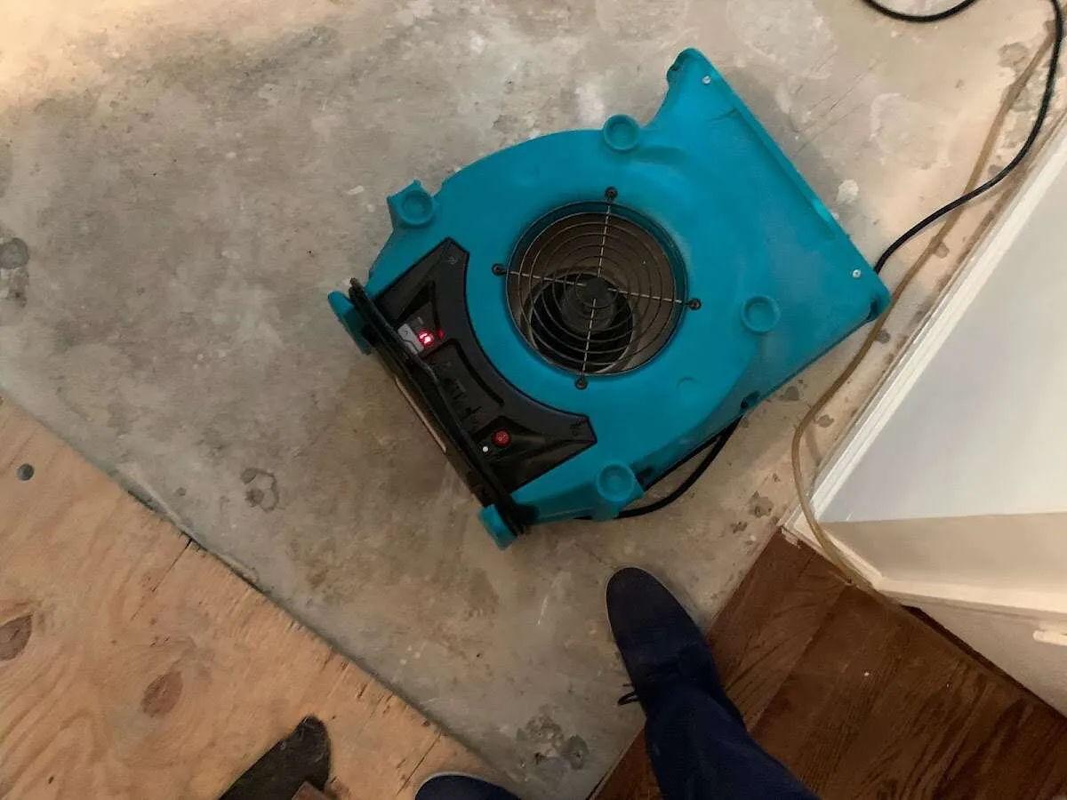Air mover drying subfloor during Commercial Water Damage Restoration in Otsego